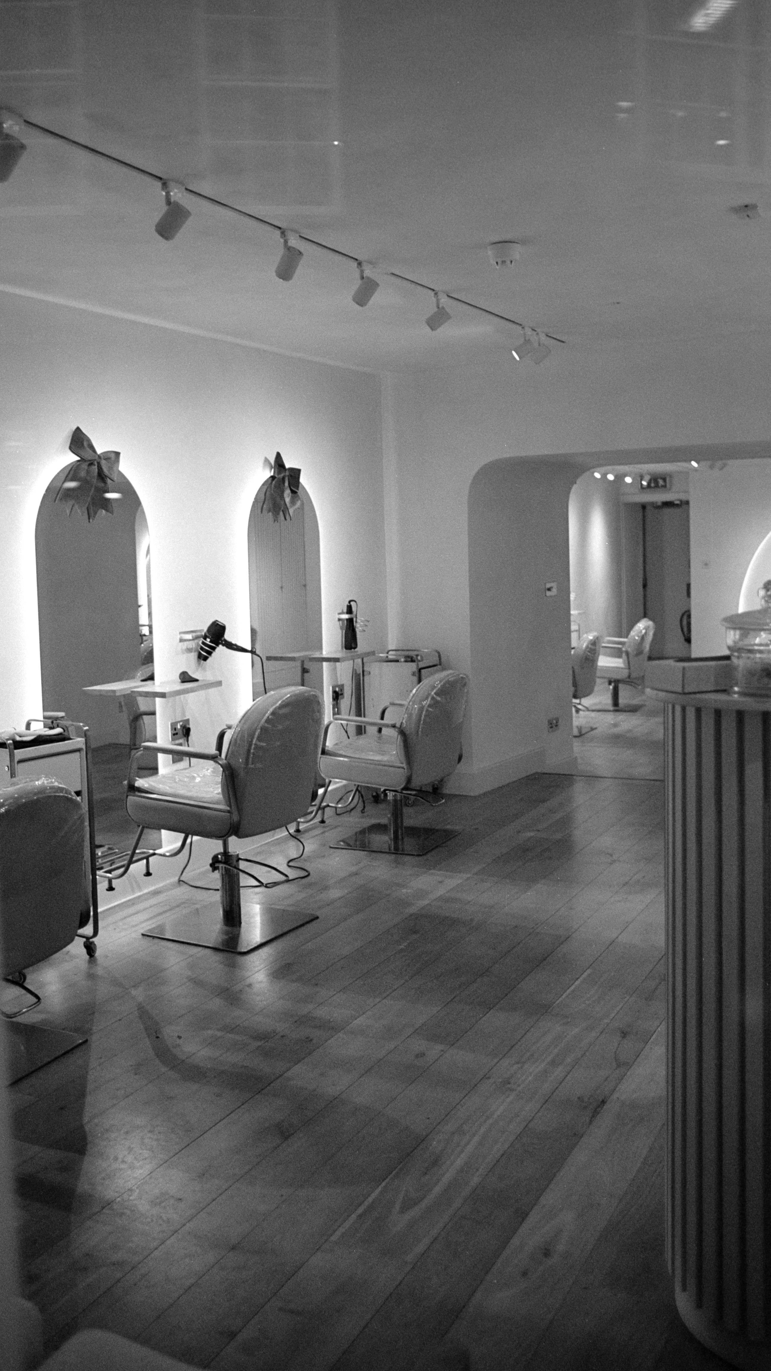 Bright, modern salon interior with styling chairs and mirrors